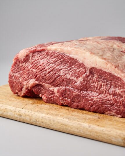 Beef Brisket — A thick, flat beef brisket joint with a distinct fat cap along one side and long muscle fibers