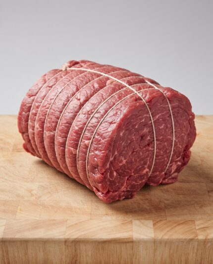 Beef Roasting Joints — A large rolled and tied boneless beef joint, a compact cylindrical shape bound with kitchen string
