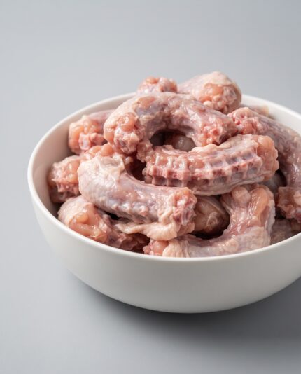 Chicken Necks — A small pile of chicken neck bones with thin skin and visible short vertebrae segments