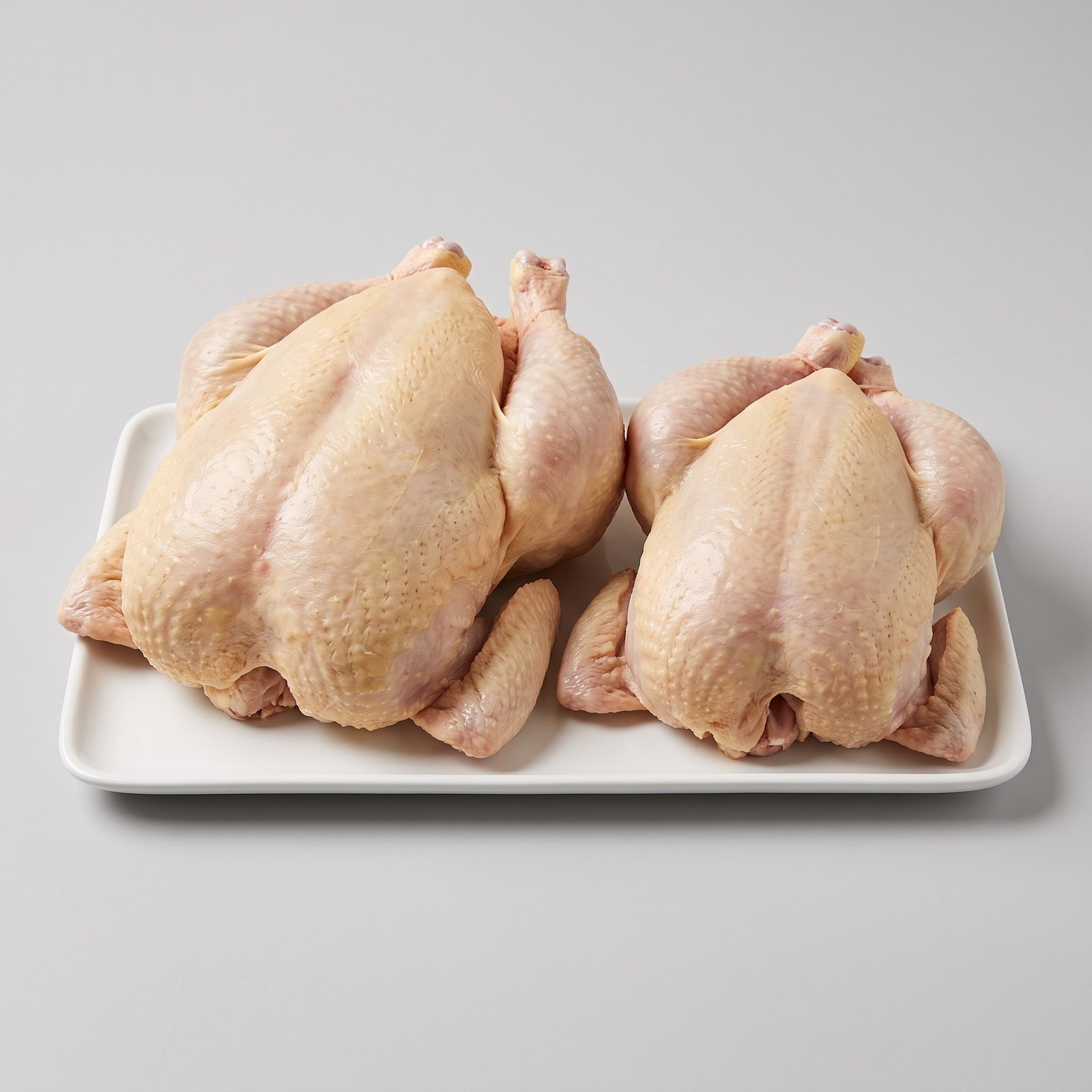 Whole Chicken — two whole birds side by side, one plump and one smaller