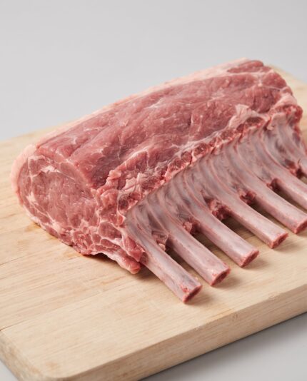 Lamb Best End — Cap Off — A rack of lamb ribs with the fat cap trimmed away, exposing the lean eye of loin meat above the bones