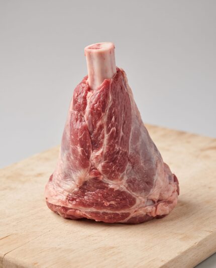 Lamb Leg Shanks — A lamb leg shank with a rounded bone protruding from one end and meat tapering around it