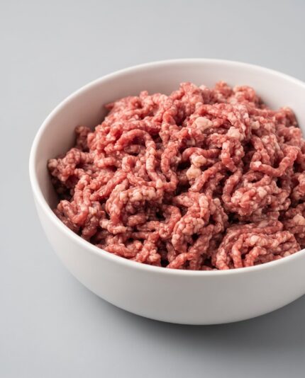 Lamb Mince — A bowl of coarsely ground lamb mince, loose reddish-pink strands with visible flecks of fat