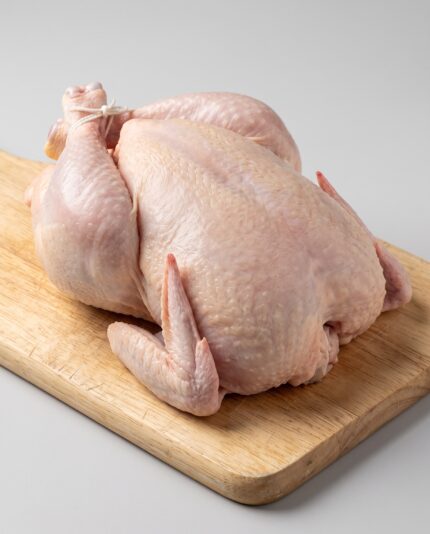 Whole Chicken 1500 — A whole raw chicken with a well-rounded breast and firm thighs, trussed for roasting