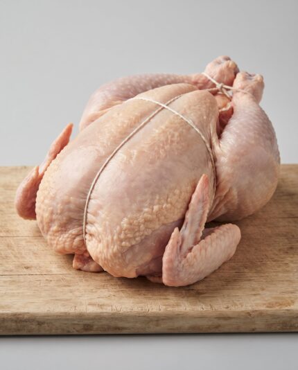 Whole Chicken 1700 — A substantial whole raw chicken with a full rounded breast and strong legs, trussed for roasting