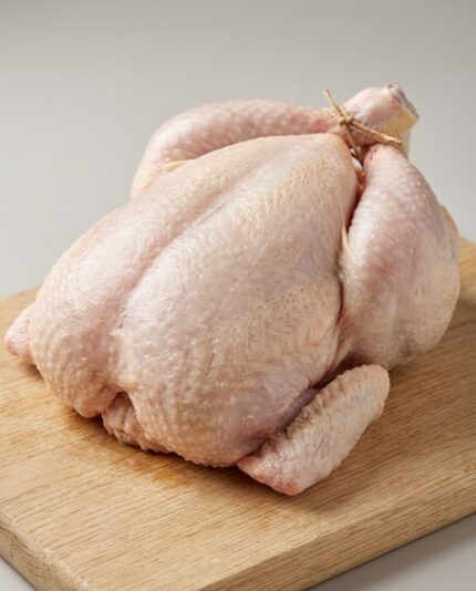 Whole Chicken 2000 — A large whole raw chicken with a broad plump breast and thick sturdy legs, trussed for roasting