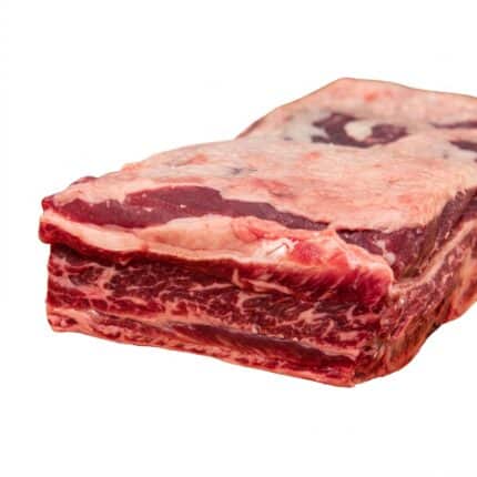 A raw slab of beef short ribs