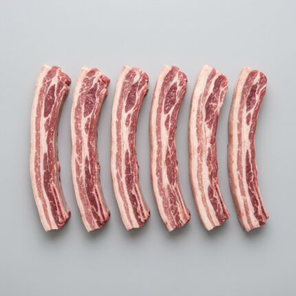 Raw lamb breast strips arranged in a row