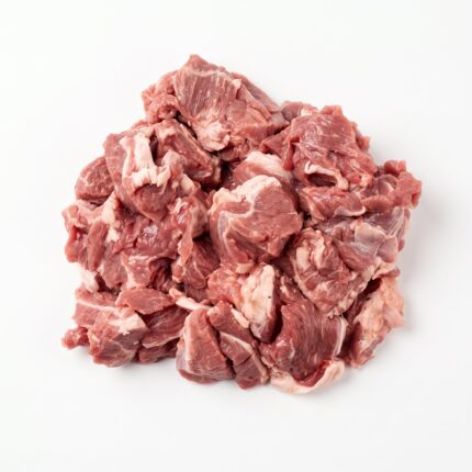 Raw diced lamb heaped on a white surface