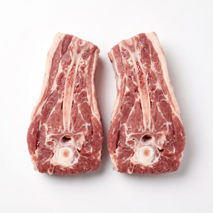 Two raw lamb neck racks split lengthwise