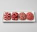 A white tray with four piles of raw meat: diced lamb, diced beef, lamb mince and beef mince